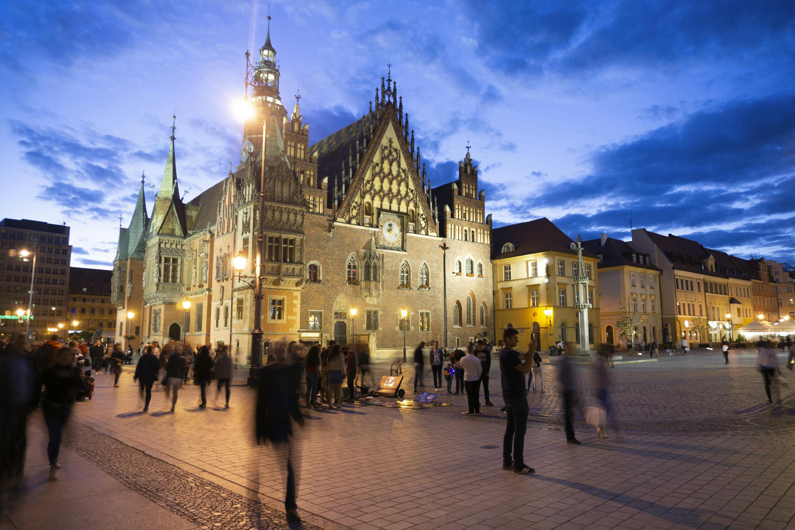 A vibrant evening at Wrocław Market Square with the historic Gothic architecture in view.